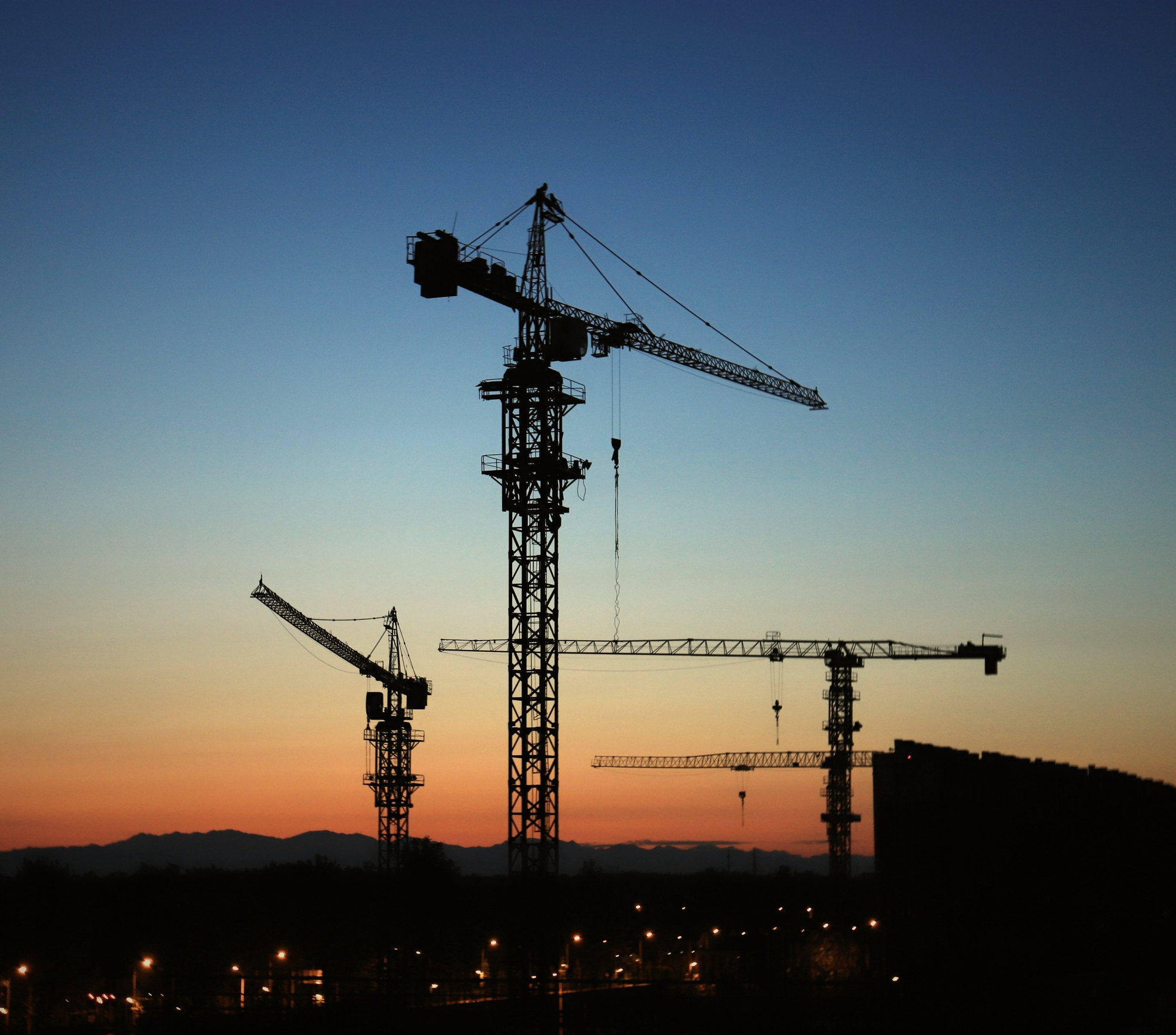Tower cranes at golden hour